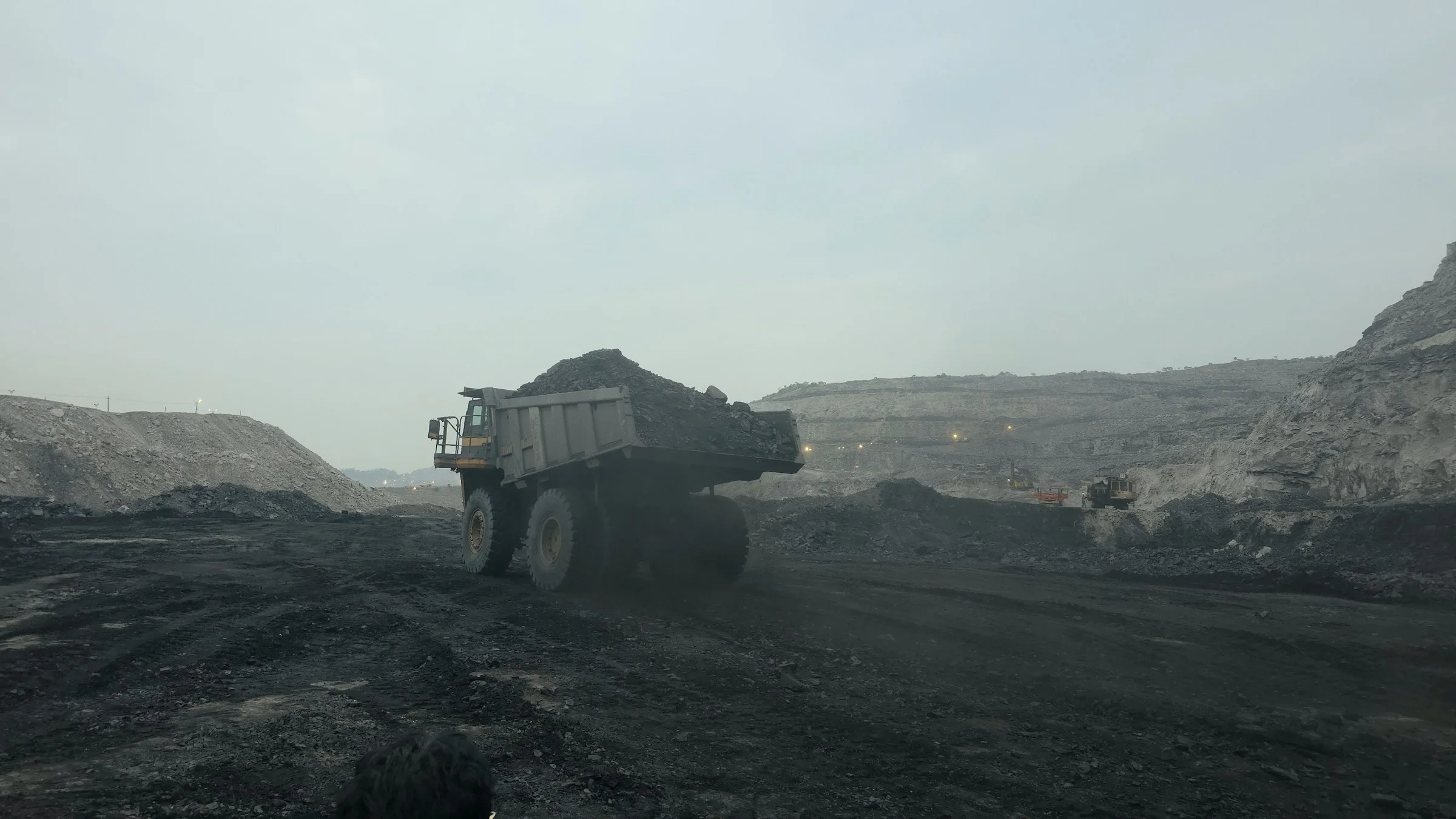 Haul truck moving through an active open-cut mine